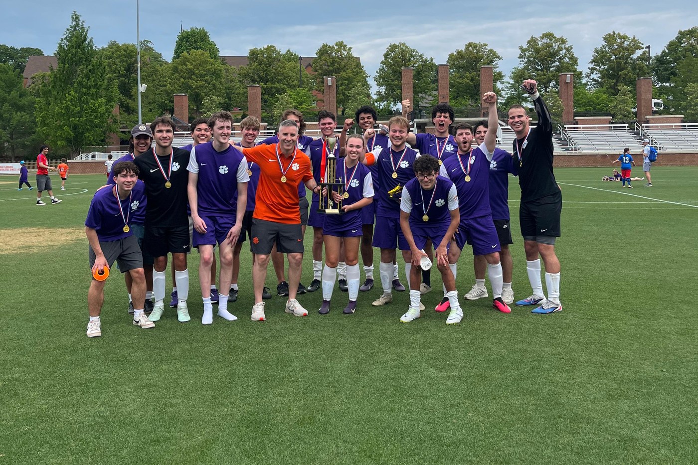 Caden Bartley with the Clemson Paralympic Soccer team and their trophy